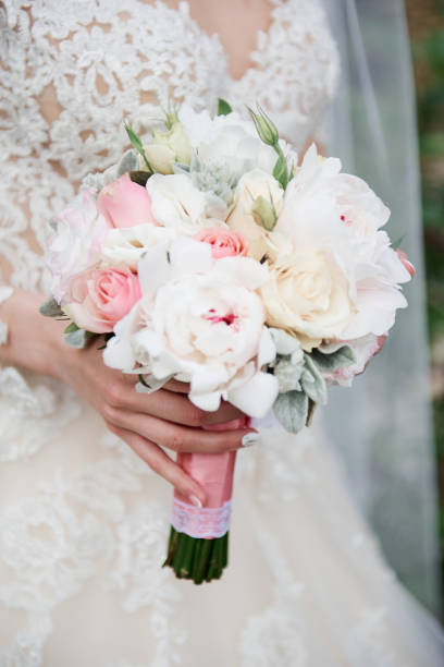 istock Bride holds a wedding bouquet in her hands 1216389681