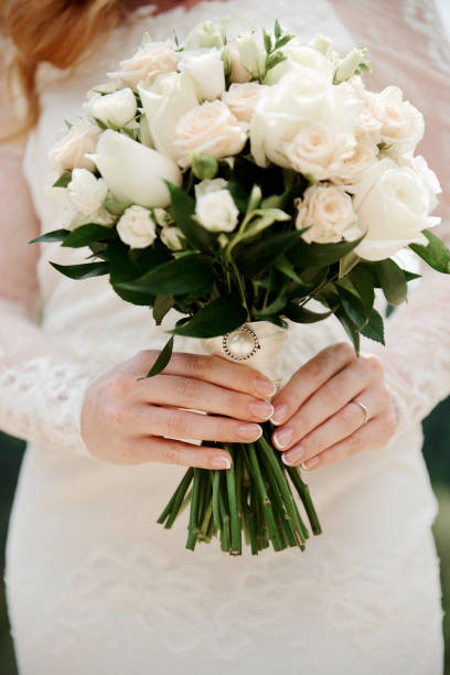 istock Bride holds a wedding bouquet in her hands 1216389682