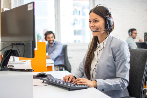 istock Beautiful customer service agent in headset working in call center 1216391467