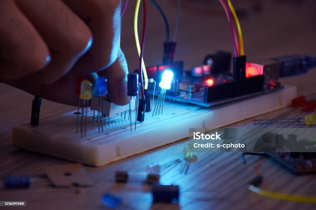 An engineer working on open-source hardware and software project, breadboard, electronic module Resistor Stock Photo