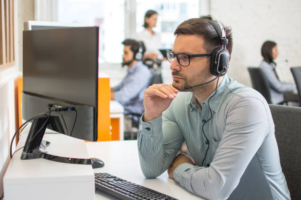 istock Focused male telephone worker agent working at office 1216391507