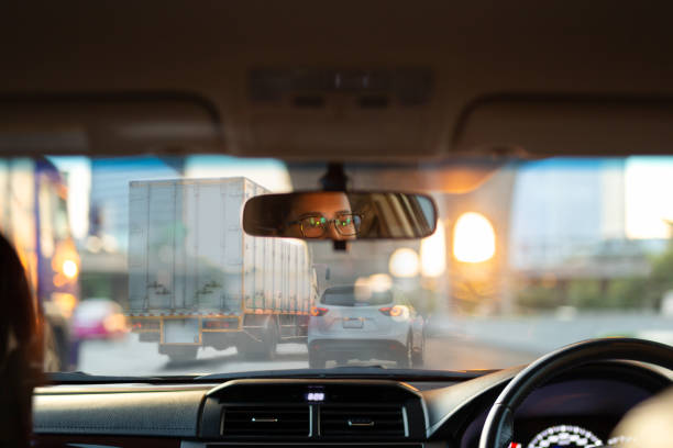istock Woman looking bored in her car while stuck in traffic jam. 1216391569
