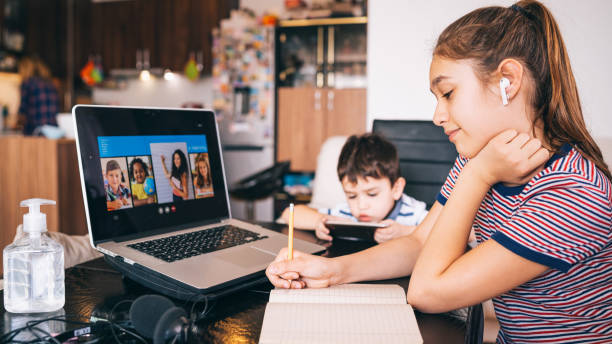 Teenage girl studying with video online lesson at home   family in isolation Homeschooling and distance learning Teenage girl studying with video online lesson at home   family in isolation covid-19. Homeschooling and distance learning epidemiology student stock pictures, royalty-free photos & images