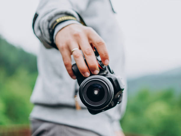 istock Male hand holding a camera 1216391796