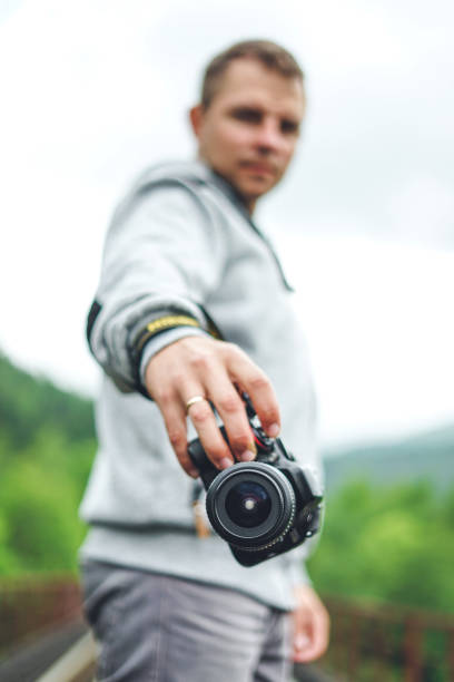 istock Man photographer holding his camera. 1216391803