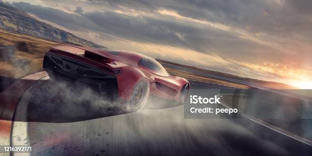 Generic Red Sports Car Drifting Around Racetrack Corner At Speed Stock Photo - Download Image Now