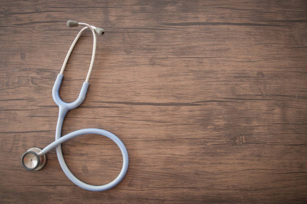 istock Stethoscope on wooden background 1216392789