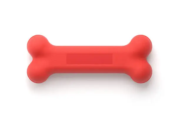 Red dog bone toy isolated on white with clipping path