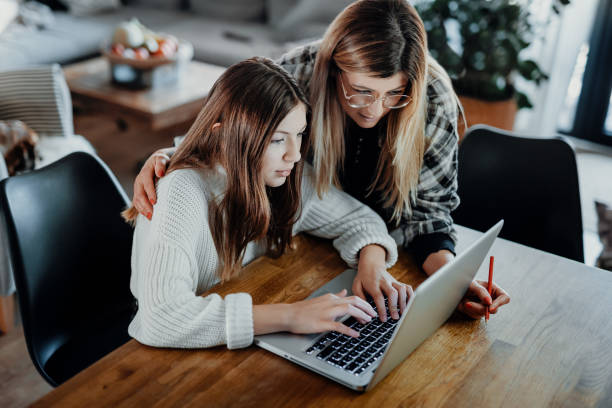 istock Mother and child doing homeschooling, e-learning at home 1216393189