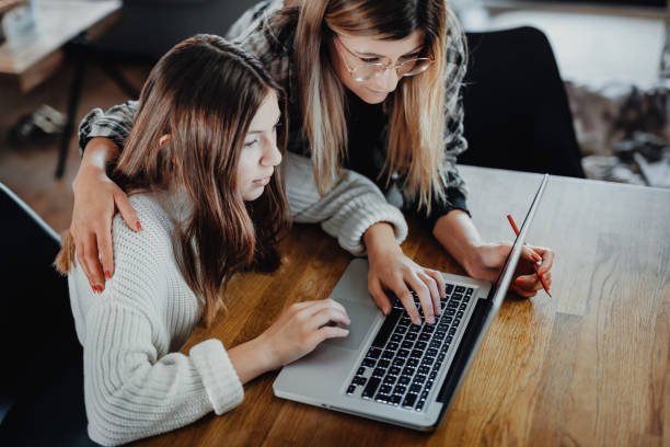 istock Mother and child doing homeschooling, e-learning at home 1216393317