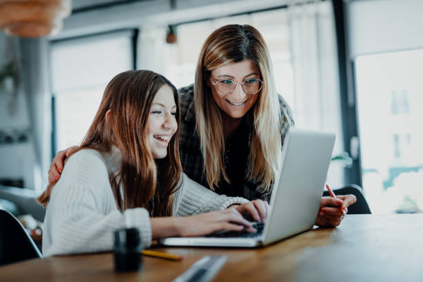 istock Mother and child doing homeschooling, e-learning at home 1216393433