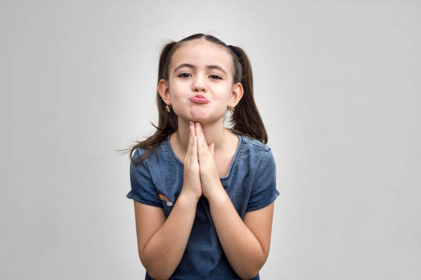 Child begging for something, making gestures of prayer. Pouting girl, having hopeful expression and wishing for something. Child begging for something, making gestures of prayer. Pouting girl, having hopeful expression and wishing for something. pleading stock pictures, royalty-free photos & images