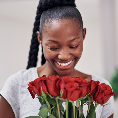 Cropped shot of a beautiful young woman holding a bunch or roses