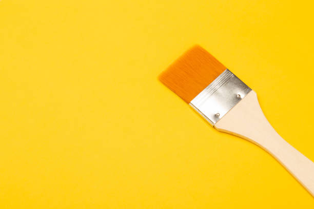 istock Paintbrush isolated on yellow background 1216397194