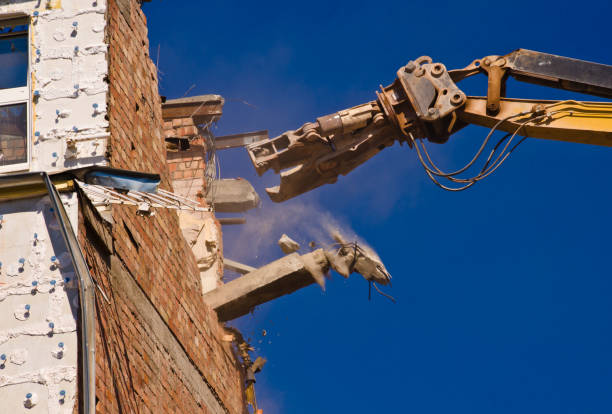 a demolition of a building with a crane with a blue sky background - old crane blue sky imagens e fotografias de stock