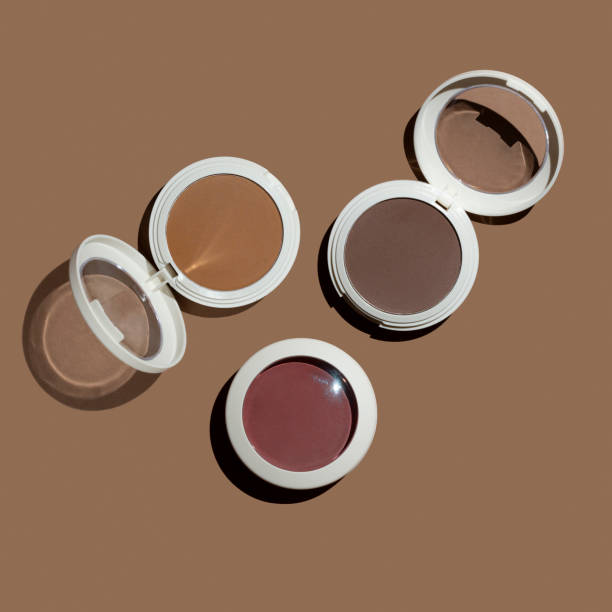 istock Three pressed powder contouring products on tan beige background flat lay. 1216398510