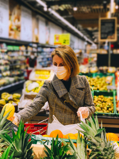istock Woman wearing protective mask shops for groceries 1216400762