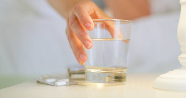 istock Woman taking morning medicine from bed 1216402109