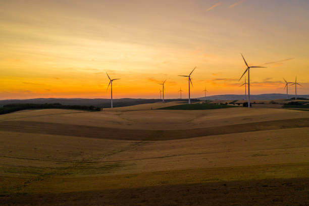 istock Aerial view of fields and wind turbines at sunset. 1216402408