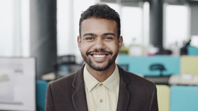 Cheerful young businessman close-up in office