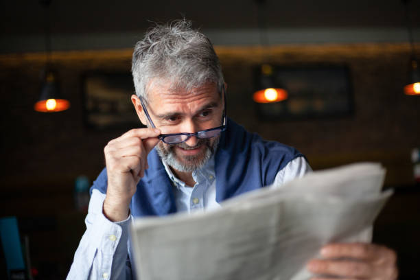 istock Senior man with newspaper 1216405525