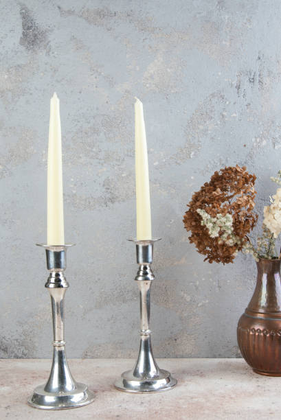 istock Antique silver candlesticks on concrete background. 1216405767