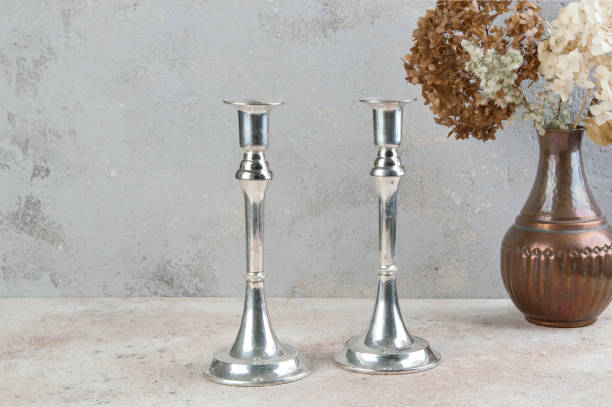 istock Antique silver candlesticks on concrete background. 1216405781