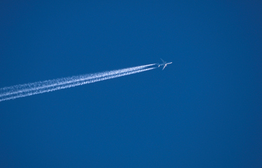 Jet aeroplane condensation trail against a clear blue sky without cloud