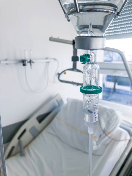 istock IV drip and hospital bed in background 1216406488