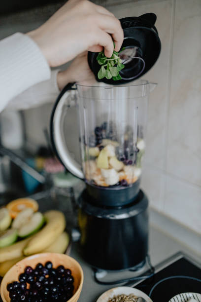 istock Making smoothie with fruits and vegetables in the kitchen 1216407364