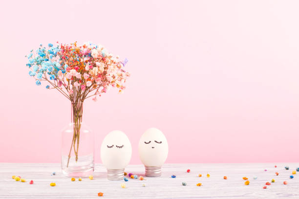 istock Portrait of an easter egg with flowers on pink background. 1216407582