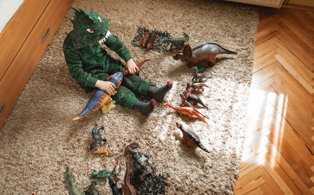 istock Toddler playing with his dinosaurs 1216409996