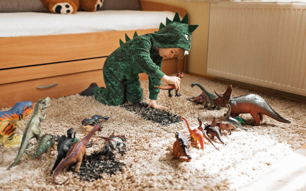 istock Toddler playing with his dinosaurs 1216410042