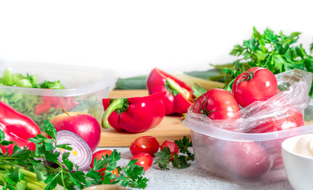 istock Various vegetables and plastic containers for storing and freezing food on the table 1216411092