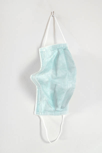 istock Medical mask hanging on the wall 1216412906