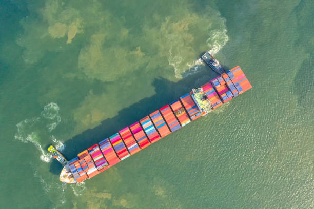 istock Container , container ship in export and import business and logistics. Shipping cargo to harbor by crane. Water transport International. Aerial view and top view. 1216413386