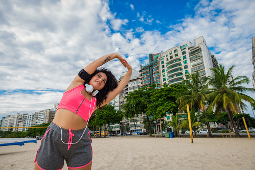 Shot of young brazilian woman stretching outdoors