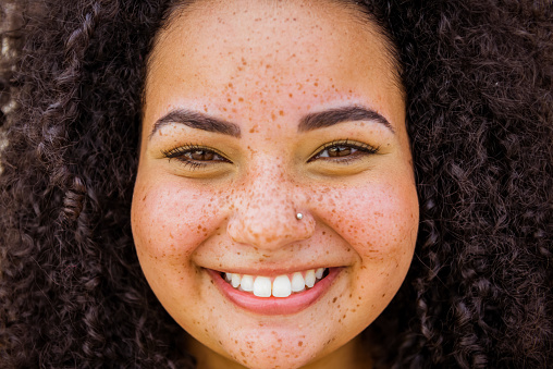 Close up of young beautiful brazilian with curly hair