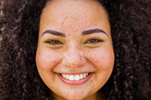 Shot of young brazilian woman Close up of young beautiful brazilian with curly hair freckle photos stock pictures, royalty-free photos & images