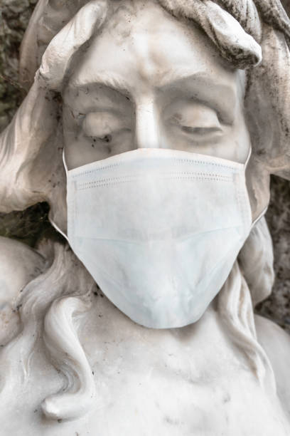 istock Statue of Jesus with medical mask 1216416421