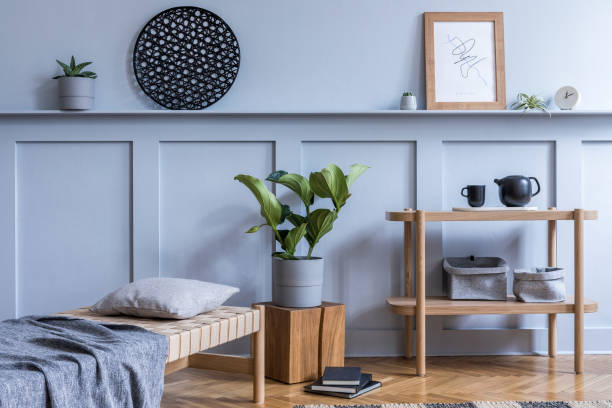 Modern interior of living room with design wooden console, chaise lounge, pillow, plaid, books, plants, mock up photo frame, decoration and elegant personal accessories in stylish home decor. Stylish scandinavian living room interior with design furniture and elegant accessories in modern home decor. art deco vase stock pictures, royalty-free photos & images