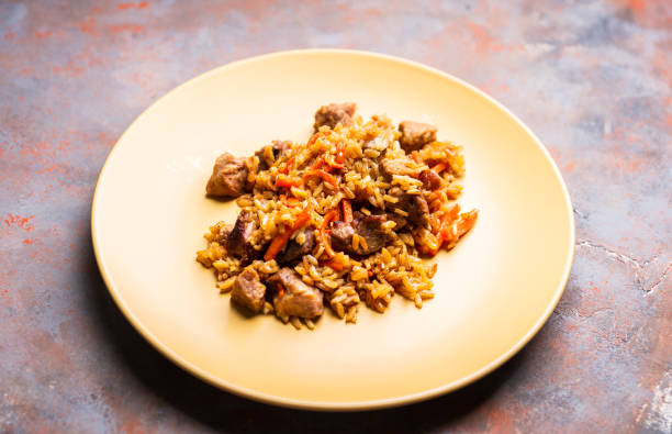 istock Traditional Uzbekistan pilaf on the rustic background 1216416722