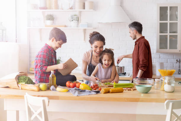 istock Happy family cooking together on home kitchen 1216417837