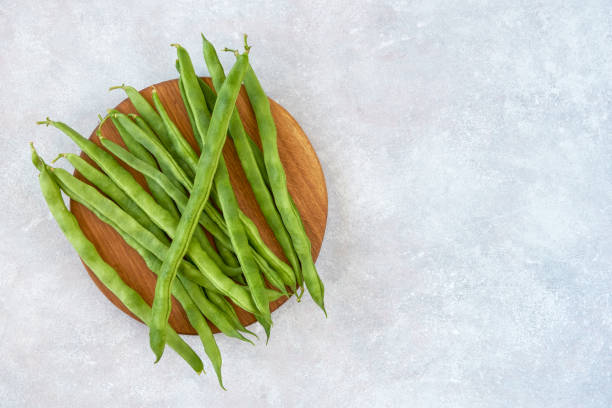 istock Green common bean  on wooden  board  .Top view with copy space 1216418393