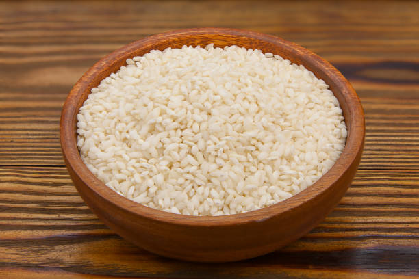 istock Raw rice groats for risotto on  plate 1216418471