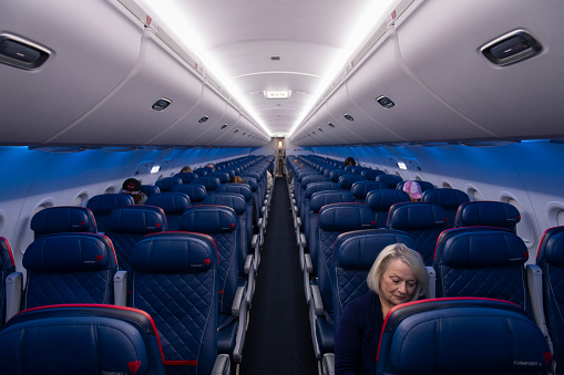 Atlanta, USA - March 21, 2020: Delta Airlines flight 0958, from Atlanta to Melbourne, FL, prepares to depart with only a handful of passengers on board due to the spreading coronavirus pandemic.