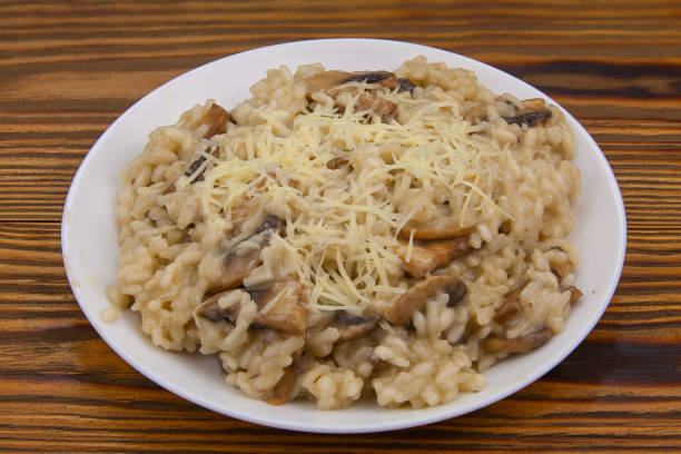 istock Tasty appetizing risotto on  white plate on  wooden table 1216419671