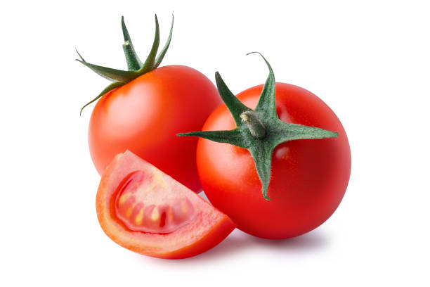 Tomatoes isolated on white background. Two whole and cut wedge of fresh, red tomato isolated on white background. Clipping path. Full depth of field. cherry tomato stock pictures, royalty-free photos & images