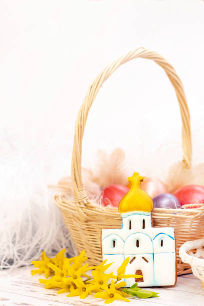 istock Easter. Colored eggs in a basket. Easter gingerbread temple. on a light wooden background. 1216421459