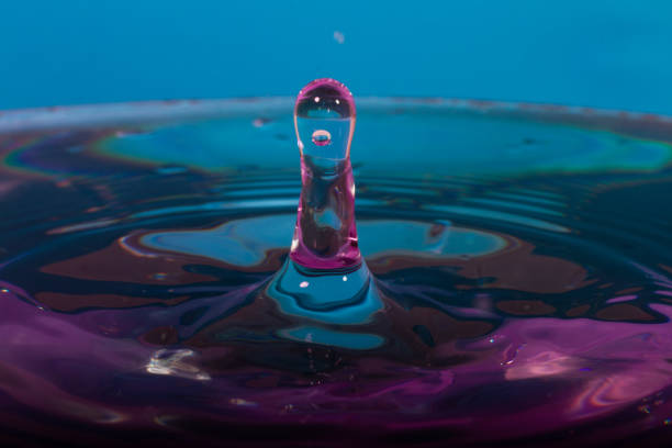 Drop creating a water structure with color stock photo